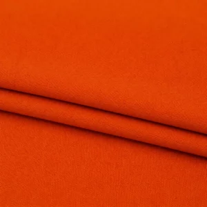 Orangefarbener hochwertiger englischer Manufakturstoff einmal gefaltet als Markisen- und Polsterstoff